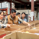 UC Davis researchers check over boxes of food from a foodbank